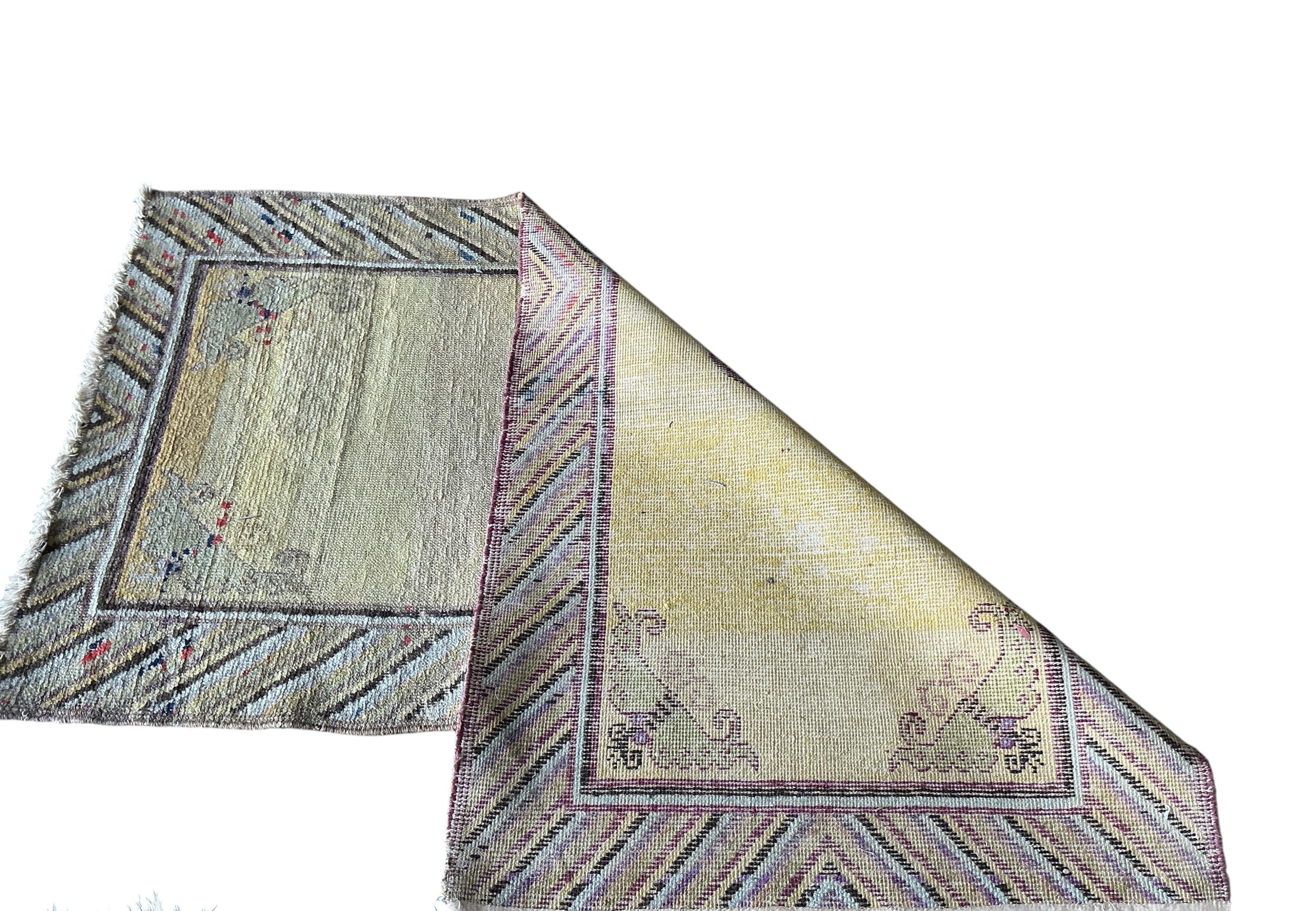 A Tibetan yellow ground rug, 134 x 70cm